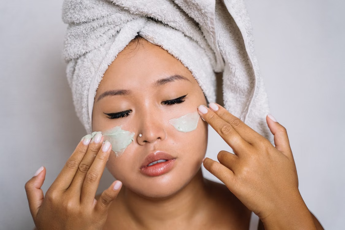 a woman is applying sunscreen