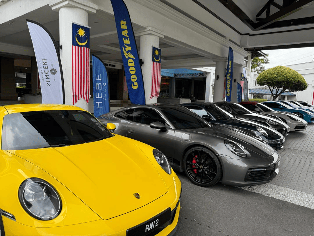 Porsche cars lined up at a community event sponsored by Hebe Clinic