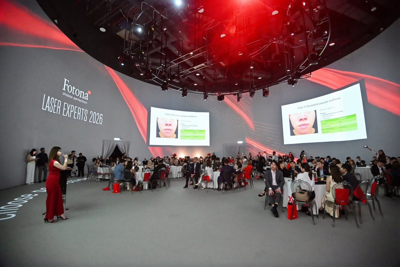Attendees seated at the Fotona Laser Experts Appreciation Night 2026, with clinical case presentations displayed on screens.